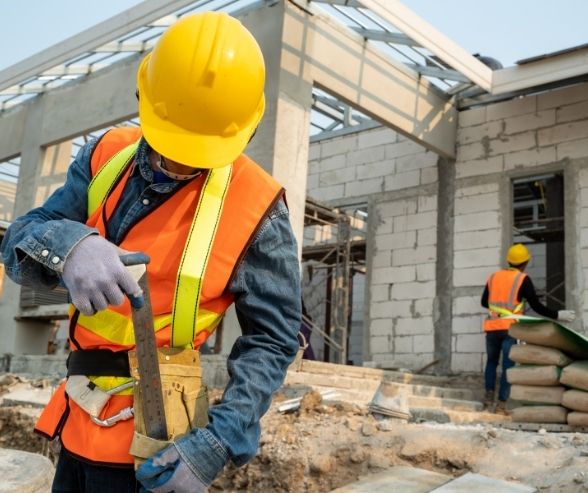 a construction worker pulling out his measuring ruler